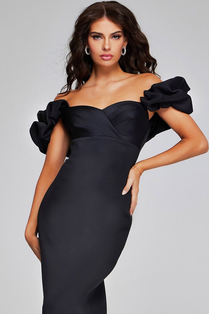Model posing in Jovani 41084 black dress, off-the-shoulder design close-up.