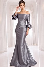 Silver off shoulder mermaid gown with satin fabric, fitted waist, and dramatic ruffle sleeves.