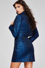 Model wearing Jovani 42134 showing the back of the navy mini dress and jacket.