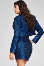 Model wearing Jovani 42134 navy dress displaying back view of crop top and patterned jacket.