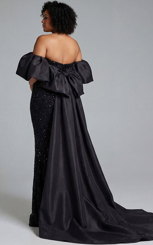 Back view of black embellished gown with oversized bow and long flowing train