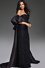 Model wearing Jovani 42137 black gown with overskirt, front view