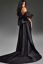 Model wearing Jovani 42137 black evening gown, back view with draped overskirt
