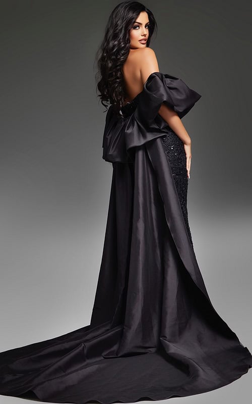 Model wearing Jovani 42137 black evening gown, back view with draped overskirt