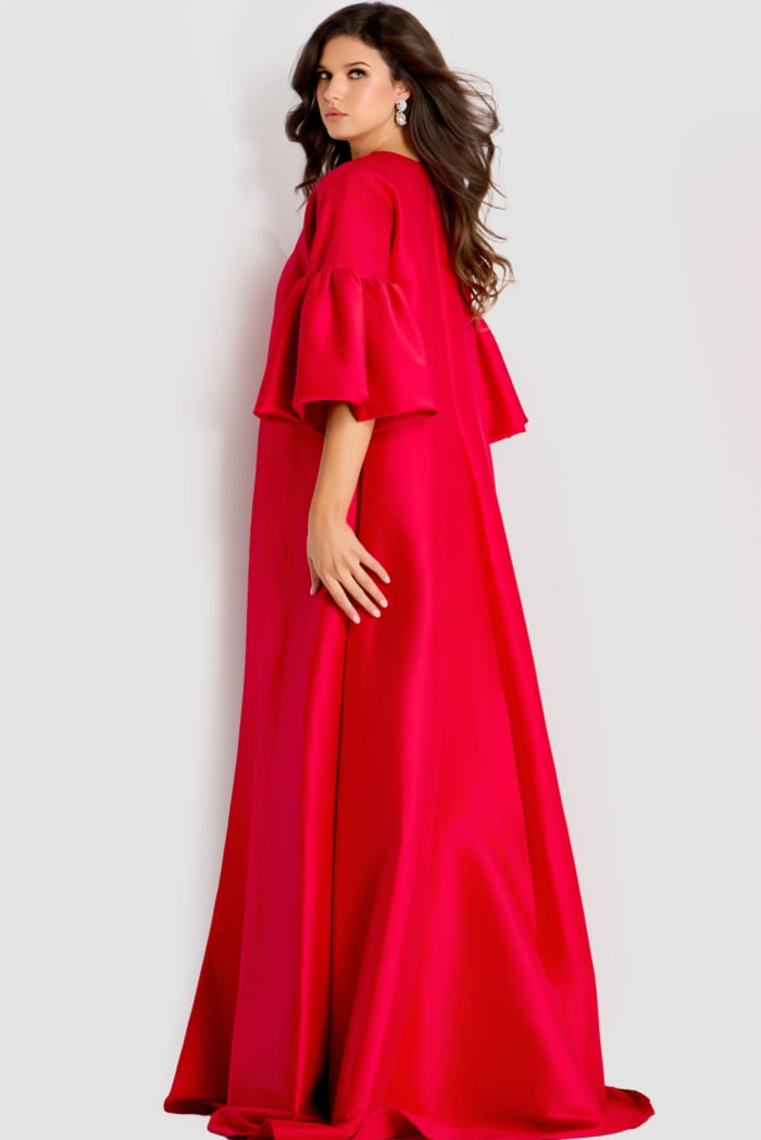 Dramatic satin cape gown featuring voluminous tiered sleeves and a flowing full-length silhouette for an elegant statement look.