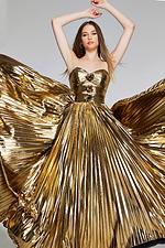 Model posing in Jovani 42335 gold gown with sweetheart neckline, front view.