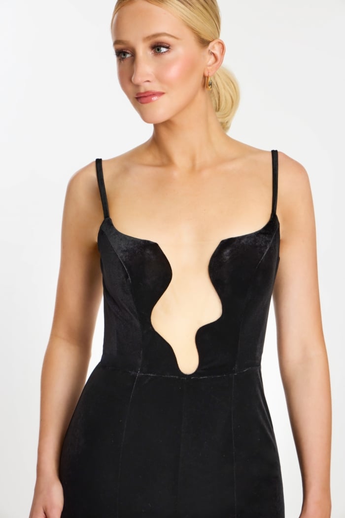 Close-up of wavy deep neckline with sheer insert on velvet jumpsuit