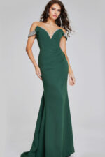 Model wearing Jovani 42394 floor-length green gown with beaded off-the-shoulder neckline from the front.