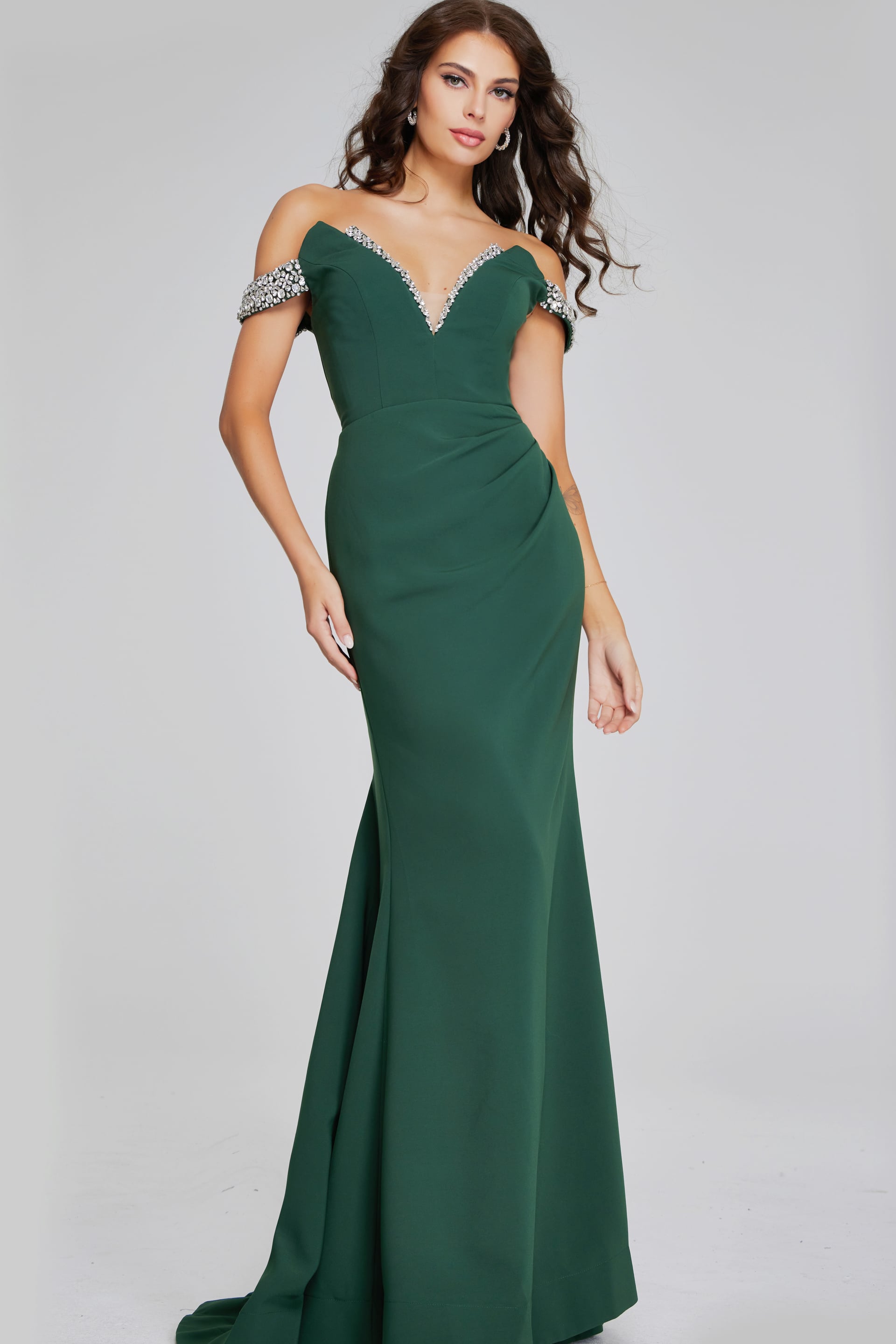 42394-HUNTER-2012.jpg Model wearing Jovani 42394 floor-length green gown with beaded off-the-shoulder neckline from the front.