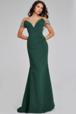 Model wearing Jovani 42394 green gown with beaded neckline from the front.