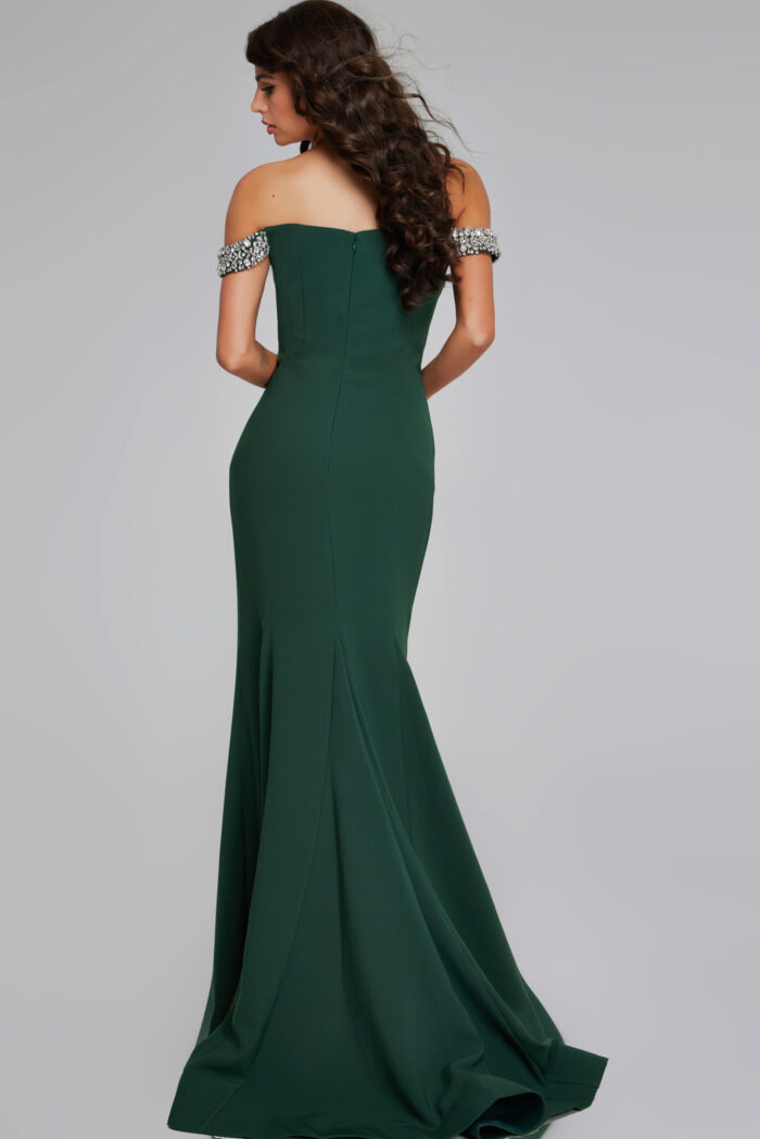 Model showing the back of Jovani 42394 green gown with a subtle flared skirt.