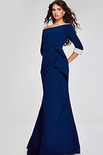 Model in Jovani 42409 navy gown showcasing off-the-shoulder design.