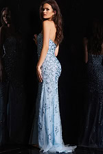 Model in Jovani 4247 blue gown, showing detailed embellishments on a fitted silhouette.