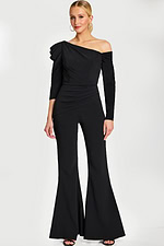 Model in fitted black jumpsuit with dramatic shoulder pleats and flare legs