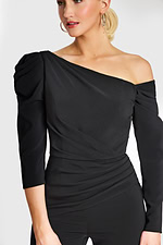 Close-up of asymmetrical neckline and ruched waist on black jumpsuit