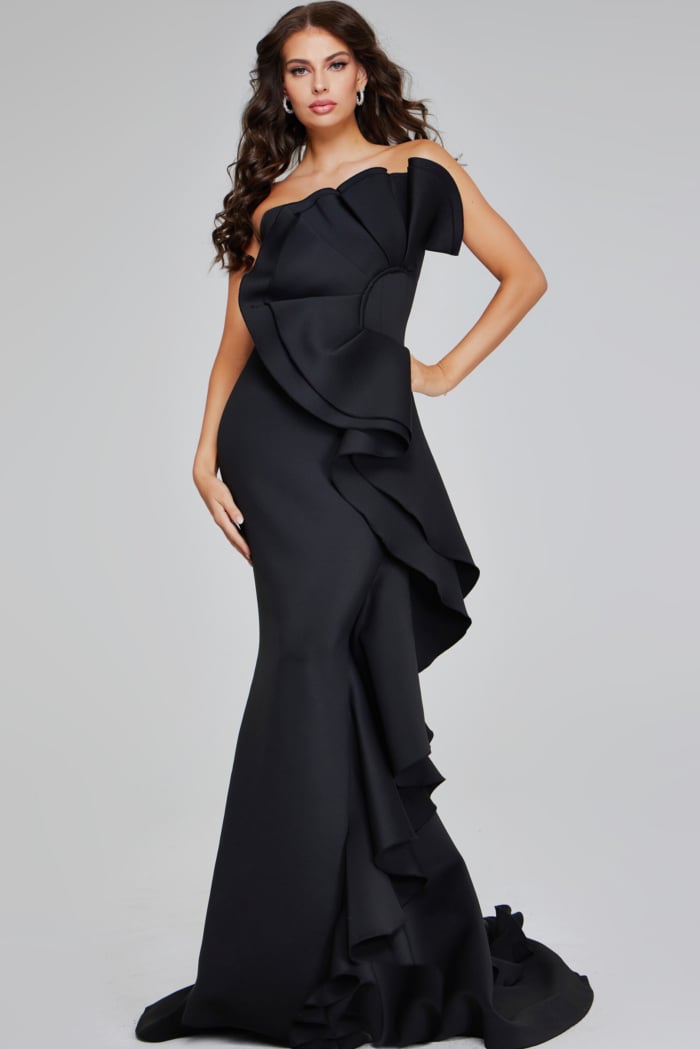 model wearing Jovani 42543 black strapless gown with oversized ruffle detail, front view