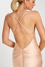 Close-up of open back with delicate straps on blush satin gown