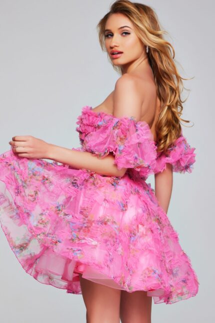 Model wearing Jovani 42573 pink dress, back view showing ruffles.