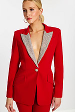 Close-up of red blazer with embellished lapel and button detail