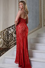 red halter plunge gown with lace overlay and high slit - three quarter view, back turned looking over shoulder on stairs