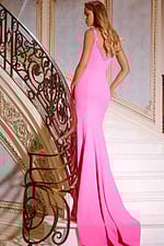 Back view of model wearing Jovani 42899 pink gown with fitted silhouette.