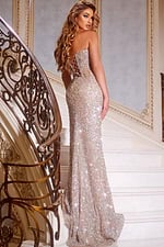 Model wearing Jovani 42920 nude gown with corset back, back view.