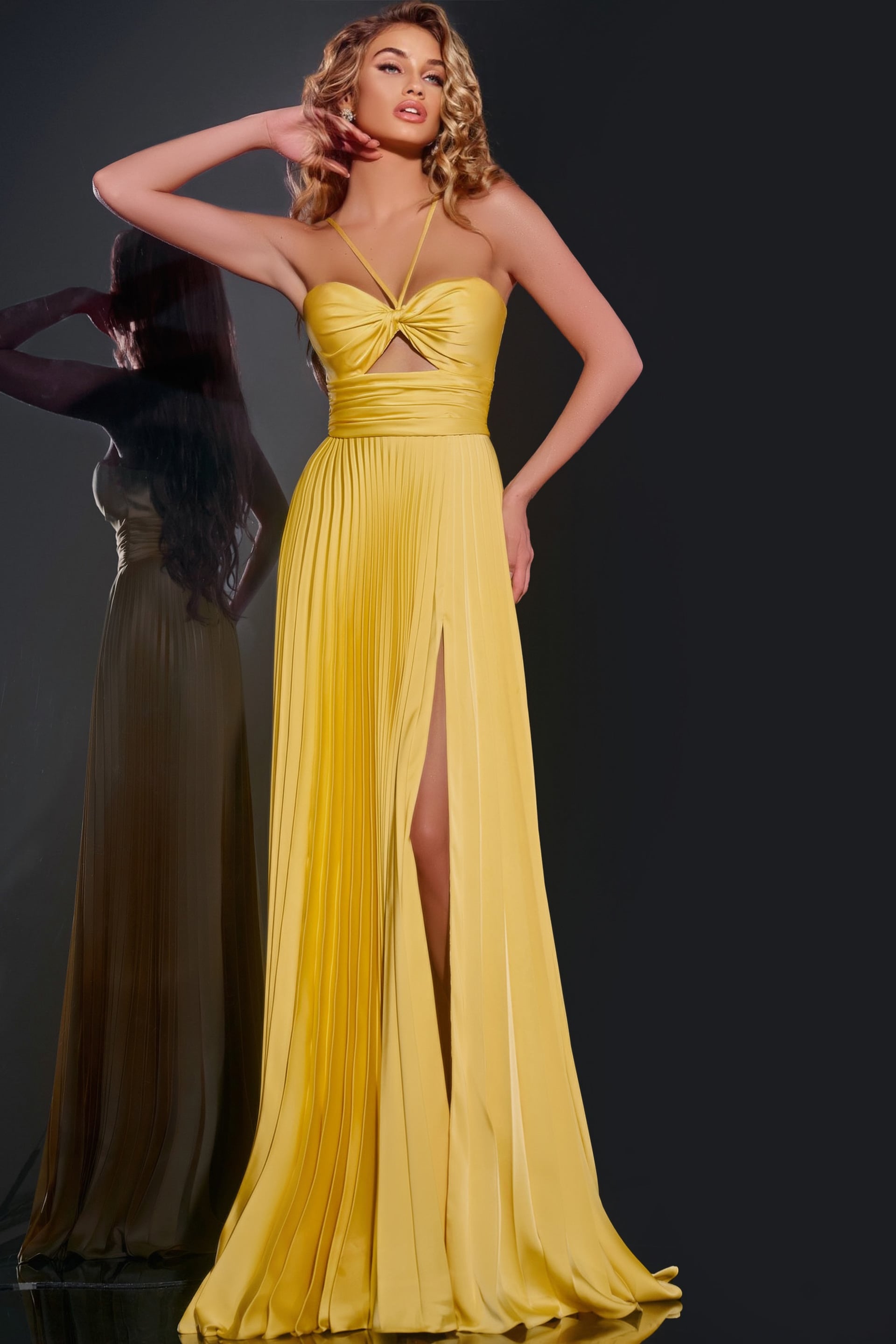 42971-2 Model wearing Jovani 42971 elegant yellow dress with twist-front bodice, front view.