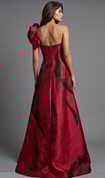 Strapless gown with dramatic red and black abstract pattern and statement shoulder bow
