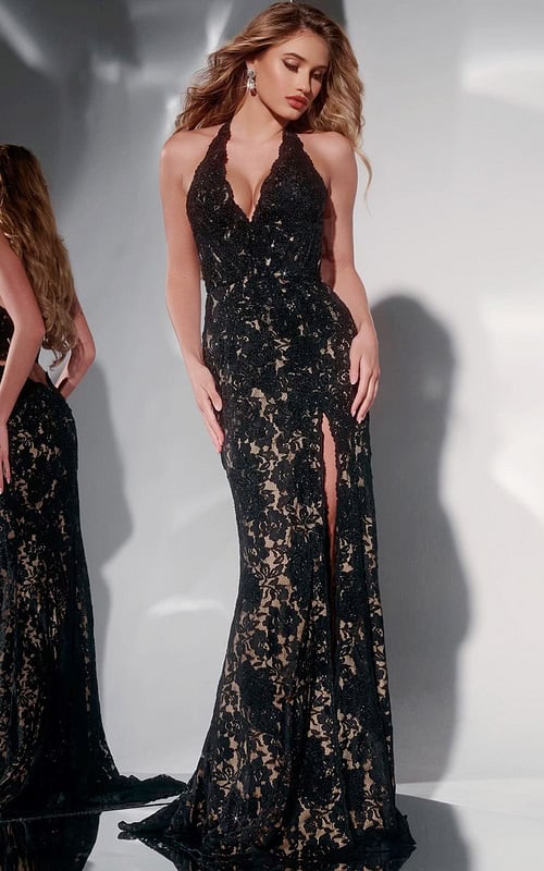 Model wearing Jovani 43097 black lace gown with halter neckline and high slit