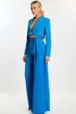 Woman wearing peacock blue tailored pantsuit with crop blazer