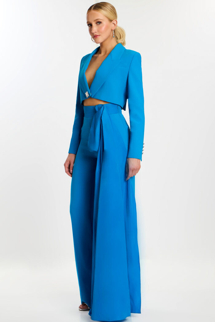 Woman wearing peacock blue tailored pantsuit with crop blazer