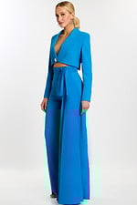Woman wearing peacock blue tailored pantsuit with crop blazer