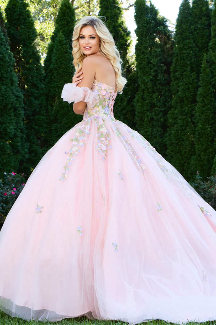 Back view of model wearing Jovani 43231 lilac ball gown showing floral appliqués.