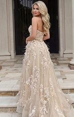 Back view of a strapless gown with floral appliqué and flowing tulle skirt