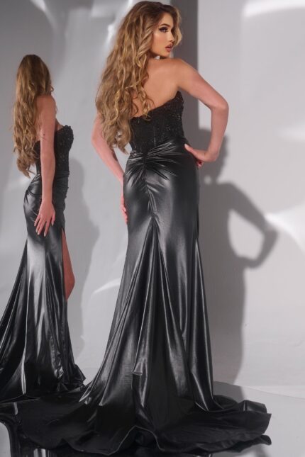 Model wearing Jovani 43267 in black showcasing back with subtle ruching.