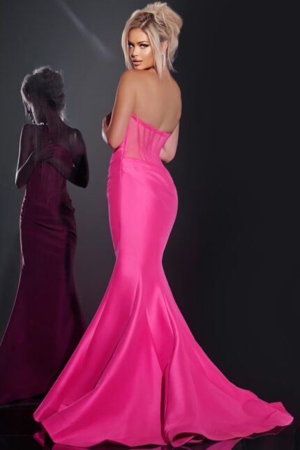 Model wearing Jovani 43350 fuchsia mermaid gown showcasing the rear corseted design.