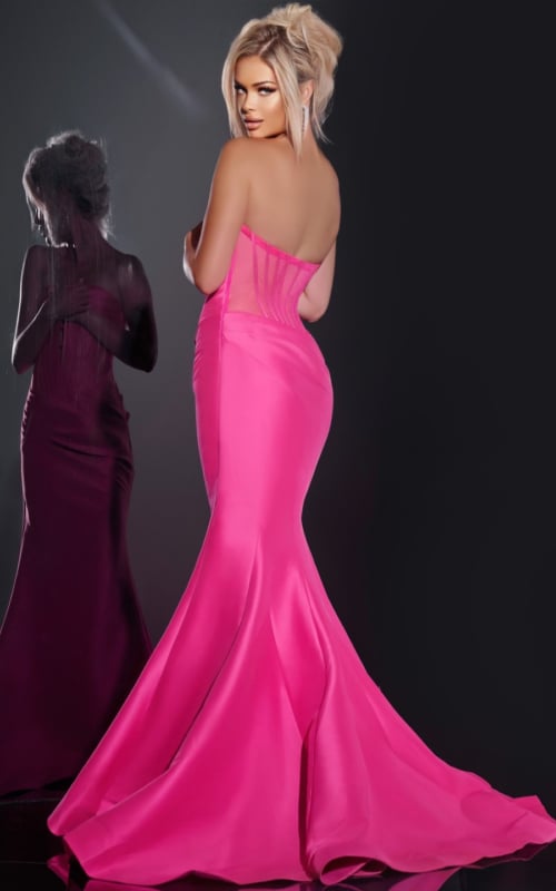 Model wearing Jovani 43350 fuchsia mermaid gown showcasing the rear corseted design.