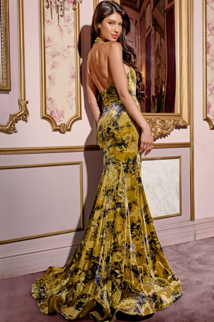 Model wearing Jovani 43388 green dress, showcasing backless design and graceful train, back view.