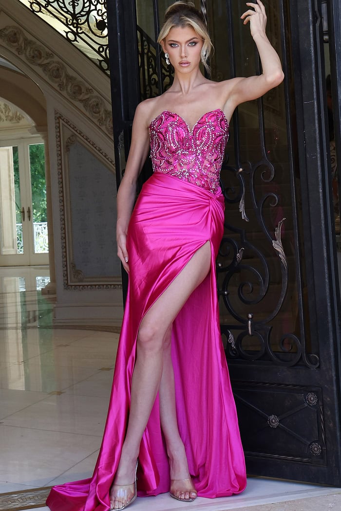fuchsia beaded corset dress with high slit - front full body, raised arm on ornate gate, leg slit