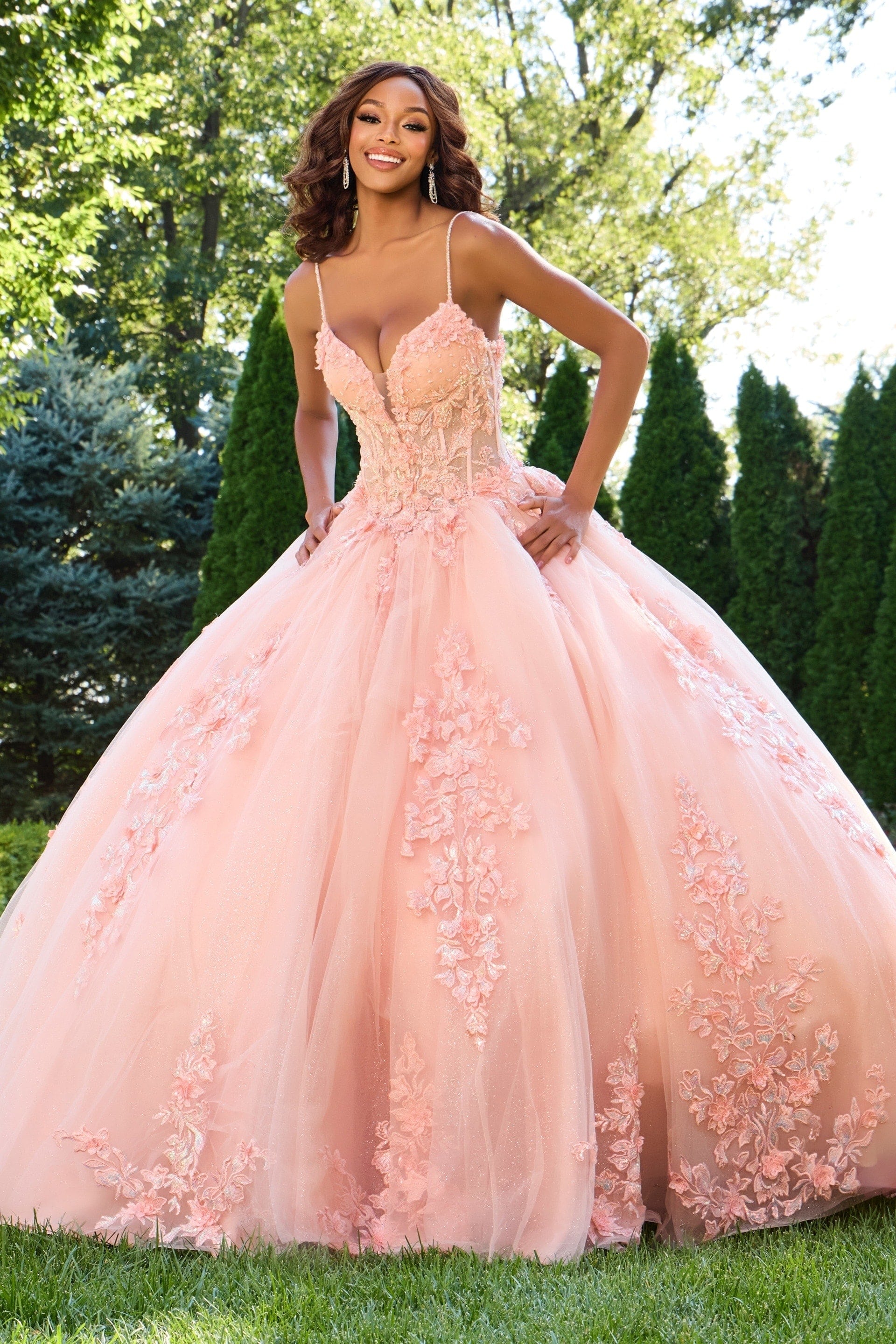 43431-2 Model wearing Jovani 43431 blush gown with floral appliqués, front view.