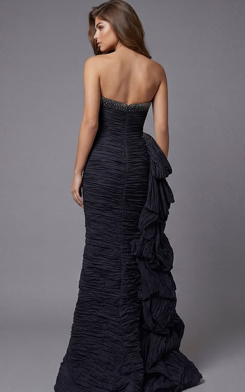 Back view of strapless ruched gown with beaded neckline detail and layered side ruffle train