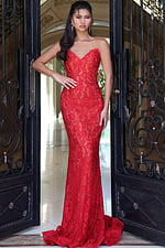 red strapless mermaid lace dress with long train - front full body, hand on hip ornate doorway