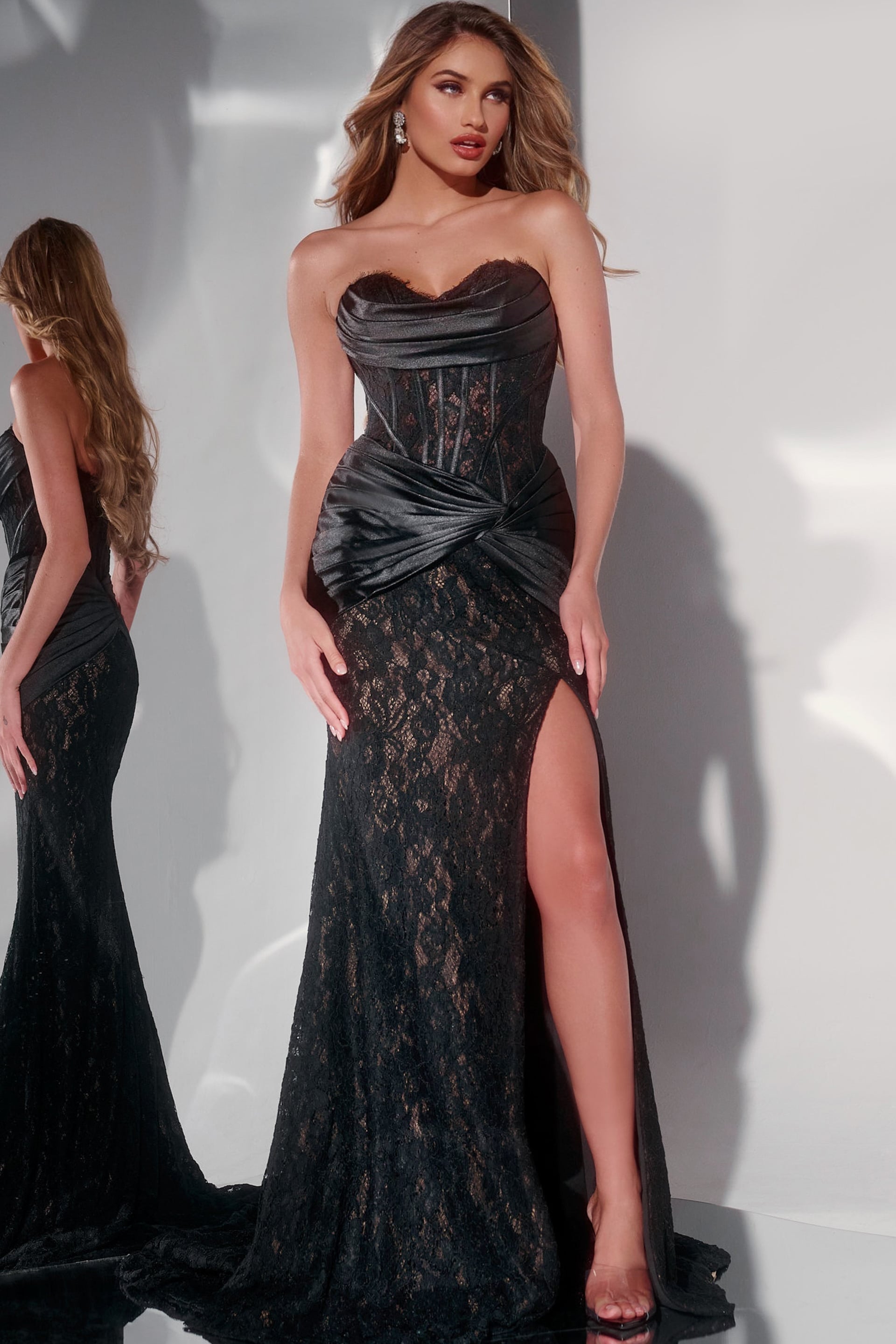 43859-1 Model wearing Jovani 43859 elegant black gown with lace overlay and high slit, front view.