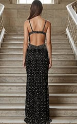 Back view of a fitted gown with an open back, thin straps, and intricate beaded detailing