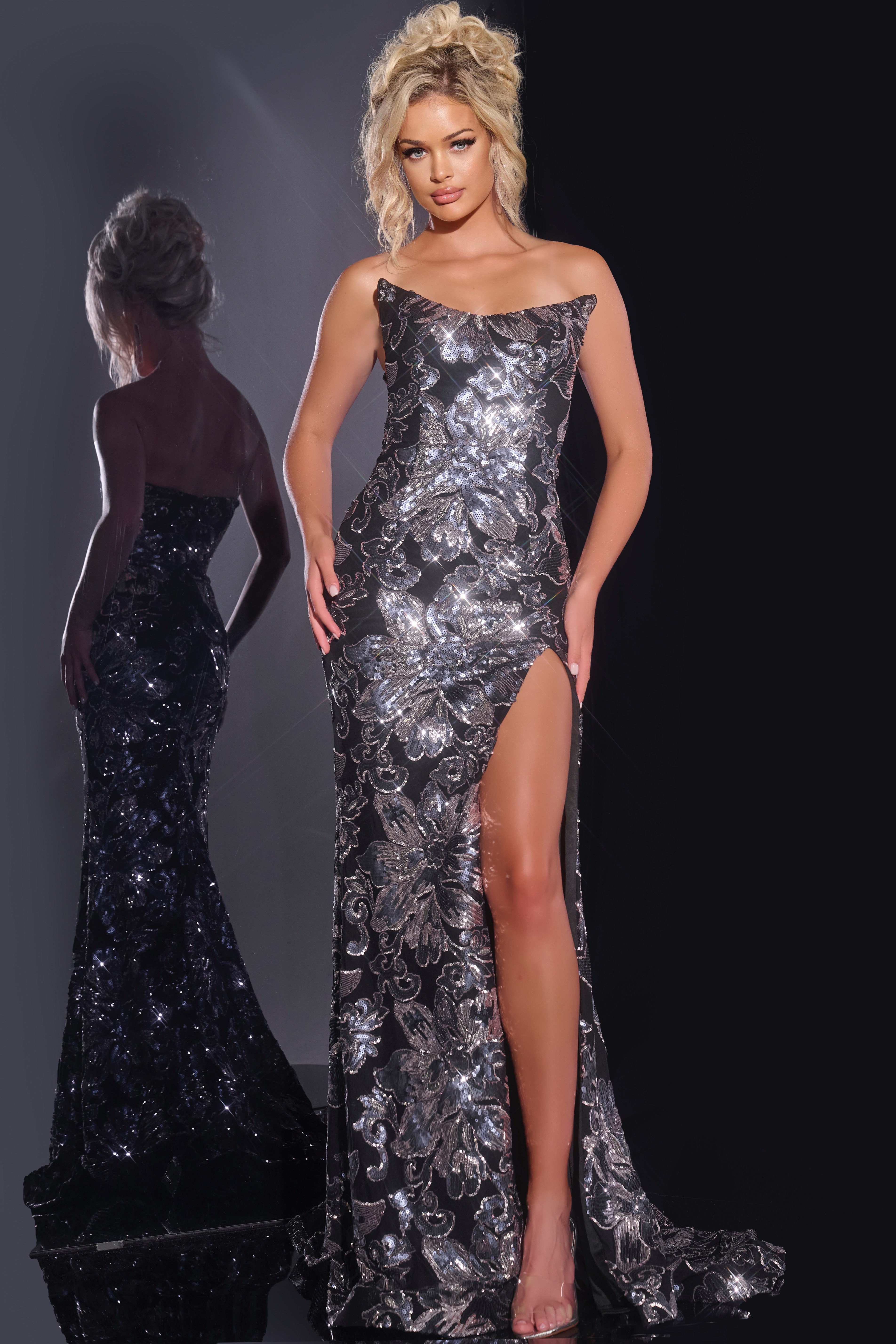 44116-1 Model wearing Jovani 44116, a dazzling black gown with sequin embellishments and a high slit, front view.