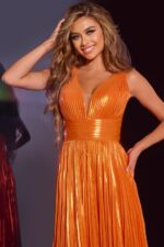 model wearing 44230 orange gown highlighting detailed waist