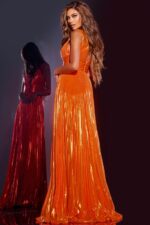 back view of model wearing 44230 orange gown with flowing skirt