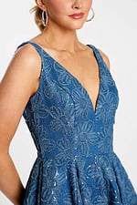 lose-up of plunging bodice with raised floral embroidery and scattered sequins