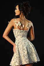 Back view of ivory sequin tweed dress with feather details on straps