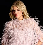 Sparkling evening gown with cape overlay and feather trim